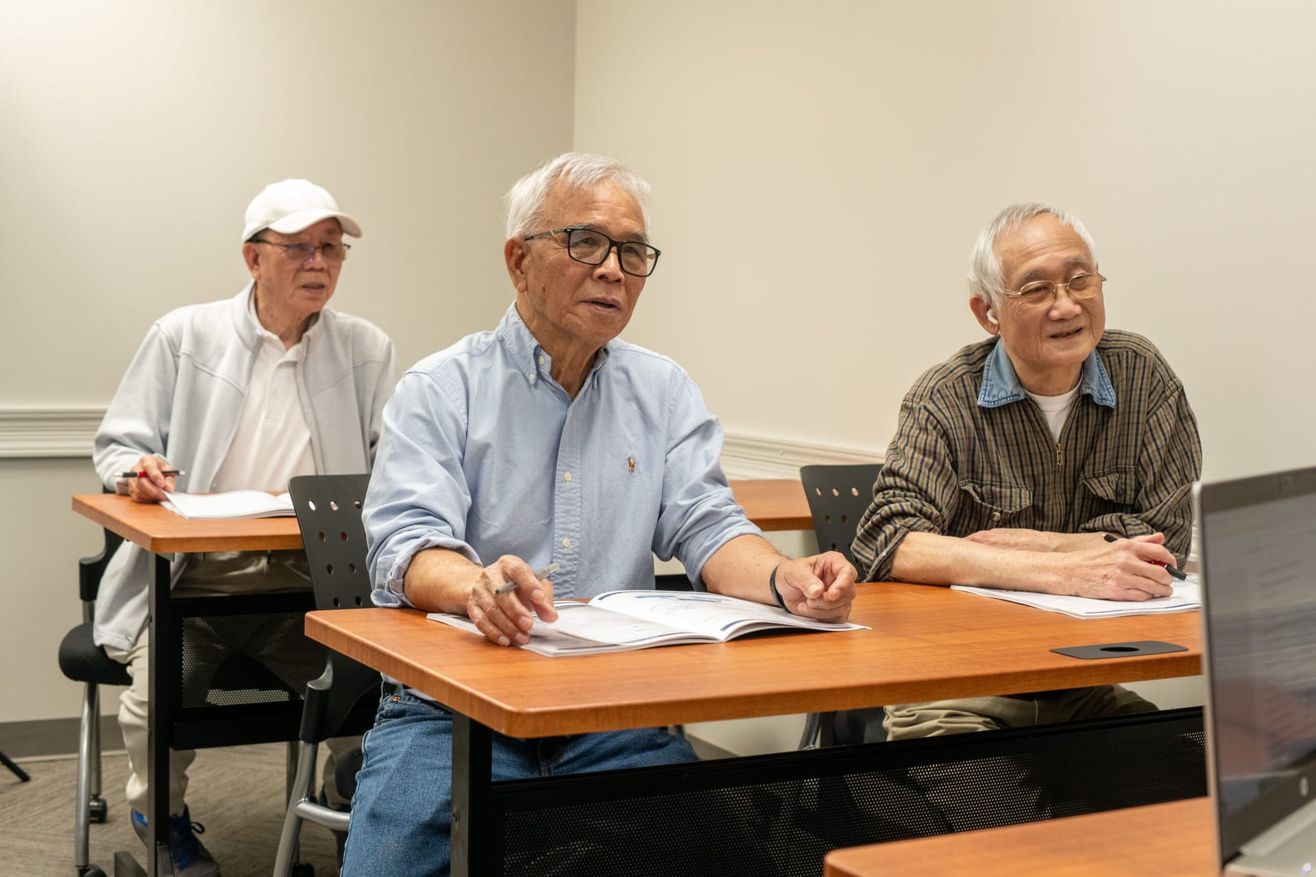Older men learning in a classroom
